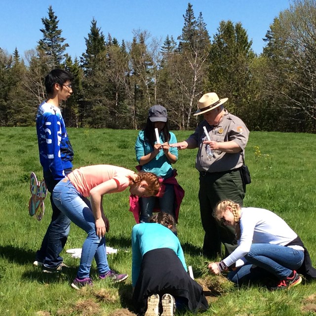 Rangers talks to group of adolescents in a field